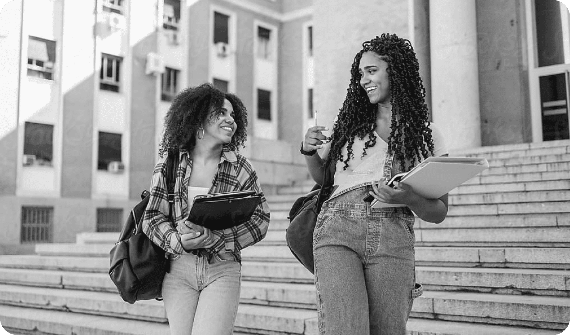 2 happy smilling university girls discussing